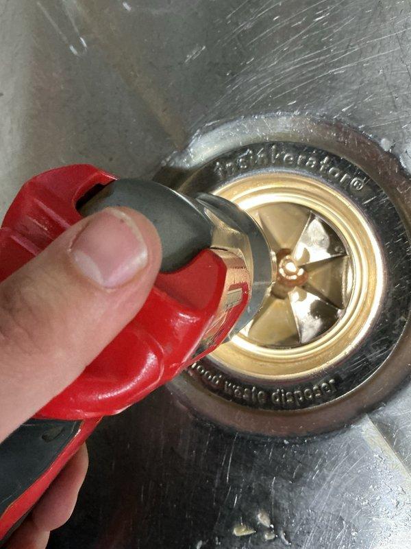 Responded to commercial facility at school entrance for non-operational garbage disposal and leaking toilets in bathroom stalls. Found the disposal's hard reset button had tripped. Performed reset procedure, inspected trap for obstructions, and tested unit to confirm proper operation. Assessed two commercial-grade toilets requiring vacuum breaker installation and repairs for active leaks. Completed part order documentation to provide repair estimate for toilet fixtures. Photographed drain assembly and plumbing components for service records.