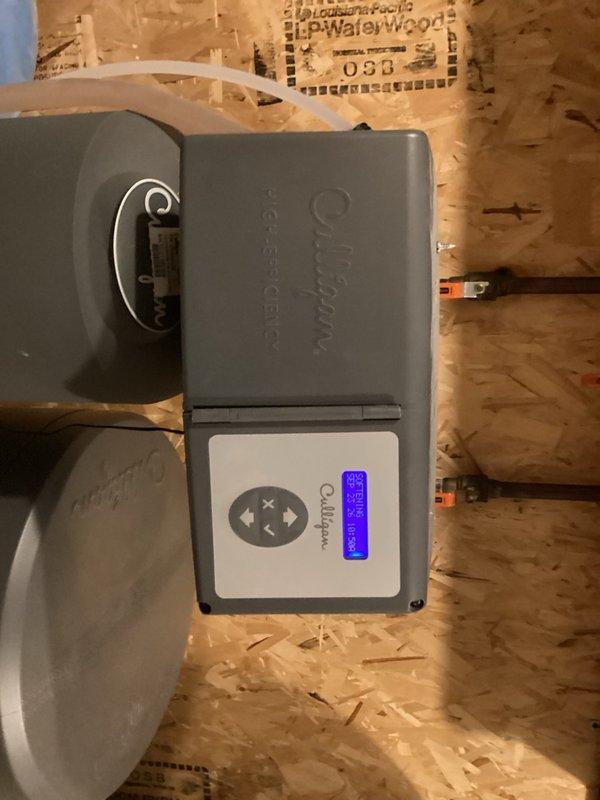 Responded to service call for tankless water heater producing loud chattering noise during hot water operation. Located unit in basement behind laundry room and performed diagnostic assessment. Determined noise was caused by mineral buildup requiring descaling flush. Completed full system flush and descale procedure to eliminate operational noise and restore proper function. Inspected electrical connections and control panel operation. Verified unit operating quietly with normal hot water delivery upon completion.