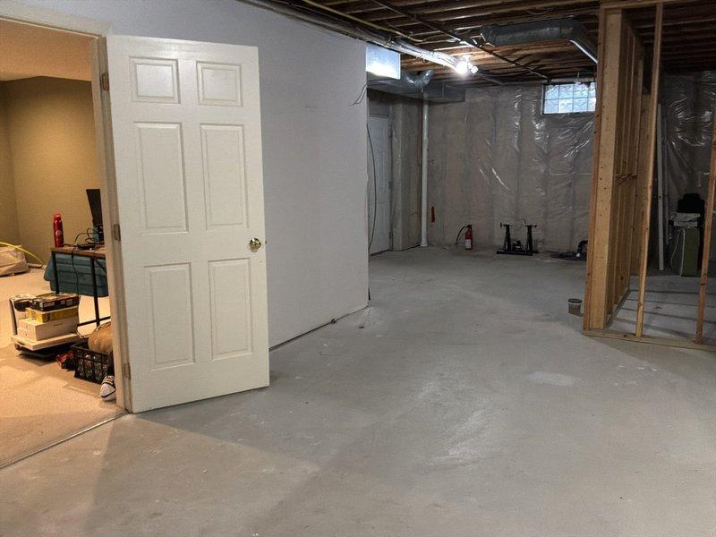 Conducted on-site evaluation for water heater replacement in residential basement location. Assessed existing plumbing infrastructure and available space for installation of either 50-gallon or 75-gallon capacity unit. Documented current conditions of unfinished basement area, including exposed framing, concrete flooring, and access points for equipment delivery and installation. Reviewed venting requirements, gas line or electrical connections, and drainage considerations. Photographed installation site and surrounding area to prepare accurate material and labor estimate for complete water heater replacement.