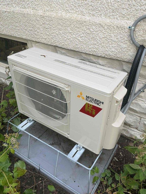 Responded to warranty call for Mitsubishi Electric mini-split system experiencing sensor reading issues on indoor head unit, particularly when exposed to direct sunlight. Performed diagnostic inspection of both indoor and outdoor components. Confirmed outdoor condenser unit requires cleaning due to accumulated debris and dust buildup on coils and filter assembly. Documented current system condition with photos showing outdoor unit mounted on metal platform stand with vegetation growth around base, and interior components displaying significant dust accumulation on filter grille and internal surfaces. Verified system operation and provided assessment for necessary maintenance to restore optimal performance.