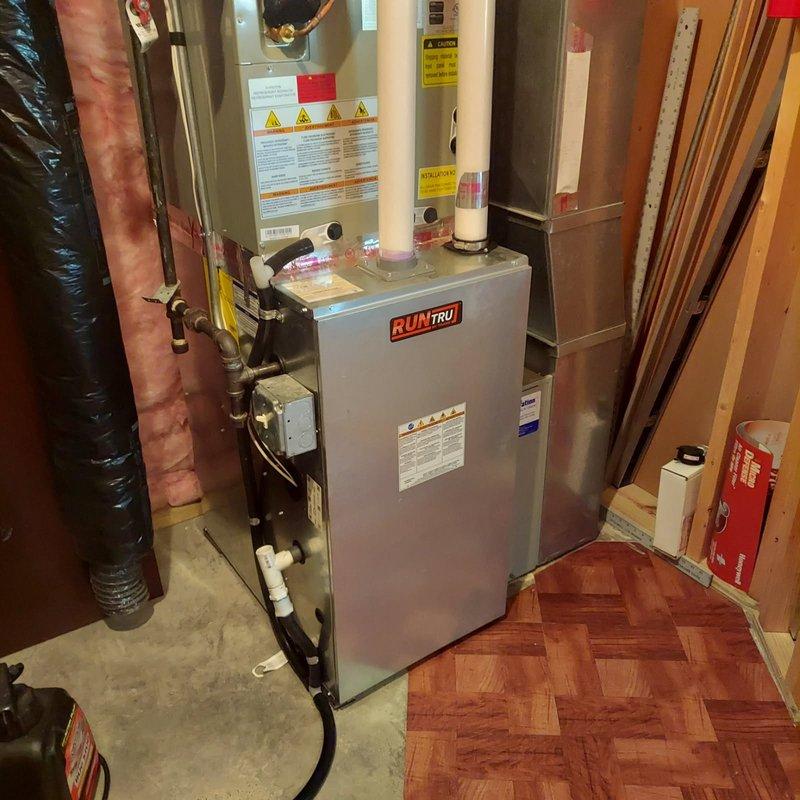 Completed comprehensive furnace tune-up and maintenance on 4-year-old RunTru gas furnace system in residential basement utility room. Performed full seasonal maintenance protocol including visual inspection of all system components, burner assembly cleaning, heat exchanger examination, ignition system testing, flame sensor cleaning, blower motor and wheel inspection, air filter evaluation, and verification of all safety controls. Checked and tested thermostat operation, confirmed proper airflow through ductwork, inspected venting system and PVC condensate drain lines for proper operation, and verified all electrical connections were secure. System tested under full operational load with no issues identified. All components functioning within manufacturer specifications. Reviewed complete maintenance procedures performed and workmanship guarantee details with homeowner on-site as requested. Unit operating efficiently with no repairs needed at this time.