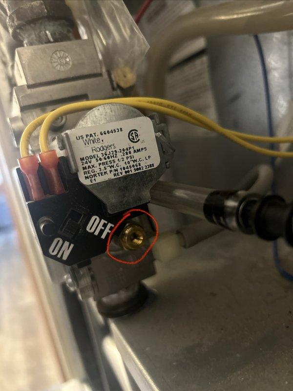 Responded to no heat call on natural gas furnace approximately two years old. Upon arrival, system was operating normally. Tested flame sensor with multimeter before and after cleaning, confirming sensor was functioning within proper specifications. Inspected burner assembly and removed debris including spiderwebs that may have been blocking gas flow to burners, which could have caused the intermittent ignition and shutdown issue reported. During inspection, discovered water intrusion dripping into furnace cabinet. Traced source to heat exchanger leak located behind collector box at heat exchanger mating point. Documented leak location with photographs for further evaluation and repair recommendations.