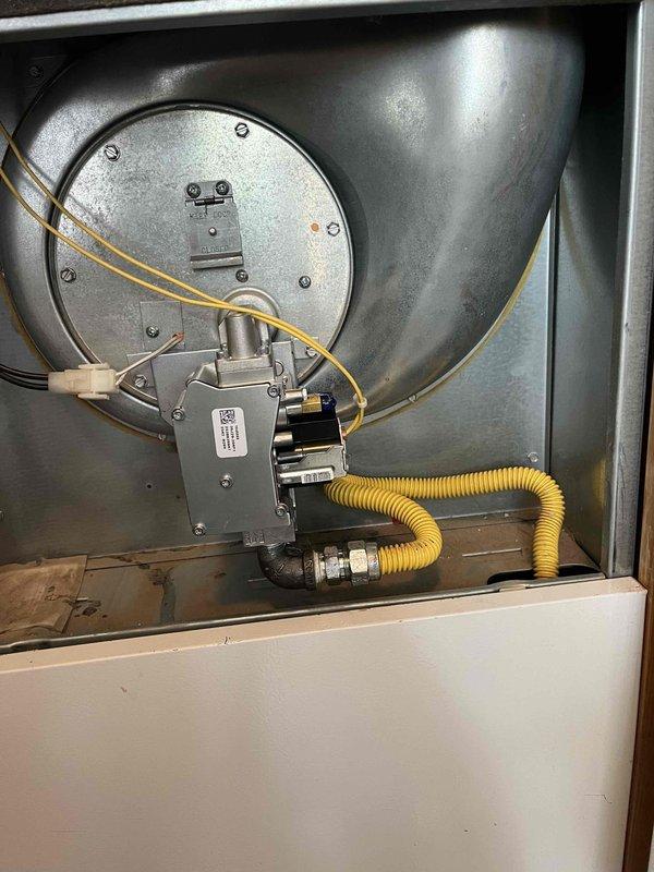 Replaced defective gas valve on residential furnace unit located in utility closet. Removed access panel, disconnected existing gas valve assembly, and installed new replacement valve. Reconnected yellow flexible gas supply line to valve inlet and verified all electrical connections to control board. Performed complete leak test on all gas connections using approved testing solution, confirming zero leaks at valve body and supply line connections. Conducted full operational test of furnace system, verifying proper ignition sequence, burner flame characteristics, and system cycling. Unit restored to safe, proper working condition.
