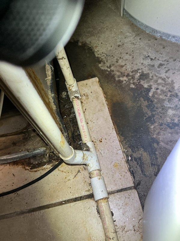 Completed furnace maintenance on a 22-year-old heating system. Upon inspection, found dirty burners affecting combustion efficiency and a leaking condensate trap causing water damage to the surrounding floor area. Verified HVAC system operation following a recent power trip incident to ensure no electrical or mechanical damage occurred. Documented existing conditions including extensive floor staining from condensate trap leak and overall system age-related wear. Provided quote for burner cleaning/replacement and condensate trap replacement to address identified issues and prevent further water damage.