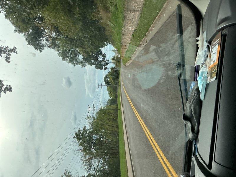 Completed phone follow-up regarding estimate discussion. Documented site conditions with photographs showing roadway access and property location for reference. Customer contact established to address estimate questions and provide requested information.