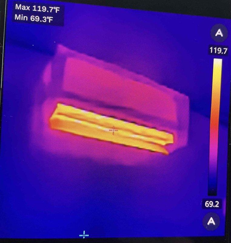 Responded to no heat call on two heat pump systems installed 24 days prior. Upon arrival, determined units were not providing heat due to remote thermostats being set to auto mode instead of heat mode. Adjusted both thermostat settings from auto to heat mode, restoring full heating operation to both systems. Verified proper heat output using thermal imaging, confirming discharge air temperatures reaching 119.7°F, indicating normal heat pump operation in heating mode.