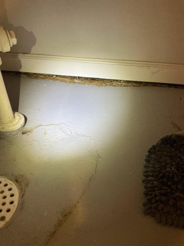 Responded to water leak originating from toilet and seeping underneath tile into laundry room below. Upon inspection, found existing skirted toilet improperly set with plastic ring causing seal failure. Removed defective unit and installed new Gerber Viper round front toilet with proper wax ring seal to eliminate leak and prevent further water damage.