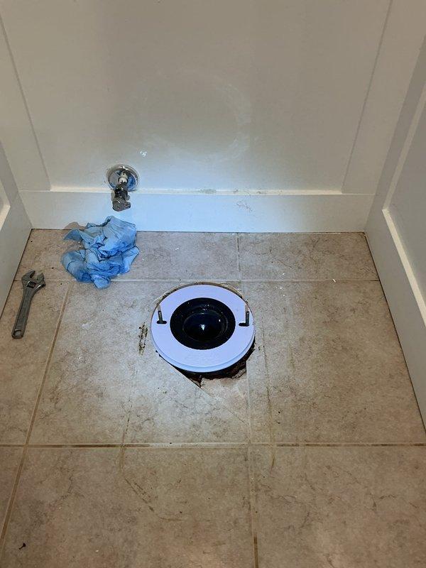 Responded to water leak originating from toilet and seeping underneath tile into laundry room below. Upon inspection, found existing skirted toilet improperly set with plastic ring causing seal failure. Removed defective unit and installed new Gerber Viper round front toilet with proper wax ring seal to eliminate leak and prevent further water damage.