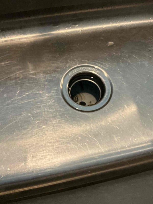 Responded to kitchen sink backup complaint where water was not draining properly despite garbage disposal functioning correctly. Performed video scope inspection of kitchen drain line and identified grease blockage restricting water flow. Cabled the drain line to full machine capacity while running water to clear the obstruction. Successfully removed grease blockage and restored proper drainage. Conducted follow-up video scope inspection confirming drain line was completely clear with no remaining blockages. Reassembled all drain components and performed operational testing to verify proper water flow and confirm no leaks were present.