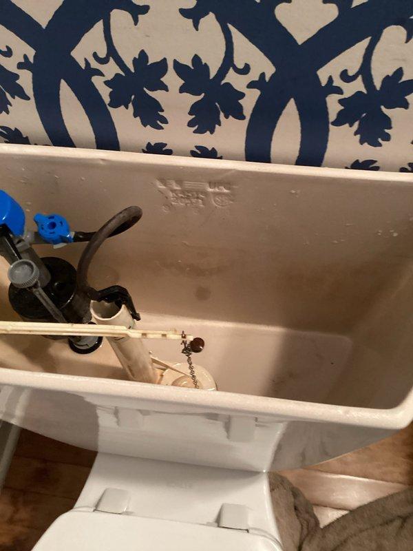 Responded to a toilet leak complaint and identified the source as a failed tank-to-bowl gasket. Removed the tank from the bowl, replaced the deteriorated gasket, and performed a complete tank rebuild including internal flush valve components and fill valve mechanism. Reassembled the unit, tested for proper operation, and verified all connections were leak-free upon completion.