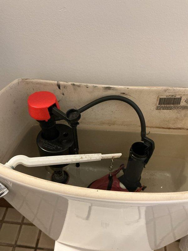 Responded to a toilet leak complaint and performed diagnostic evaluation. Upon inspection, identified active leaking from both the water supply line and fill valve assembly. The fixture stop valve exhibited severe corrosion, compromising its integrity and contributing to the leak condition. Proceeded with complete replacement of the deteriorated supply line, installing a new braided stainless steel flexible connector. Replaced the fill valve assembly with a new unit featuring improved shutoff mechanism. Due to the advanced corrosion on the existing fixture stop valve, removed and replaced with a new chrome-plated angle stop to ensure proper water control and prevent future leak issues. All connections were tested for leaks and proper operation. Toilet tank refill cycle verified for correct water level and shutoff functionality.