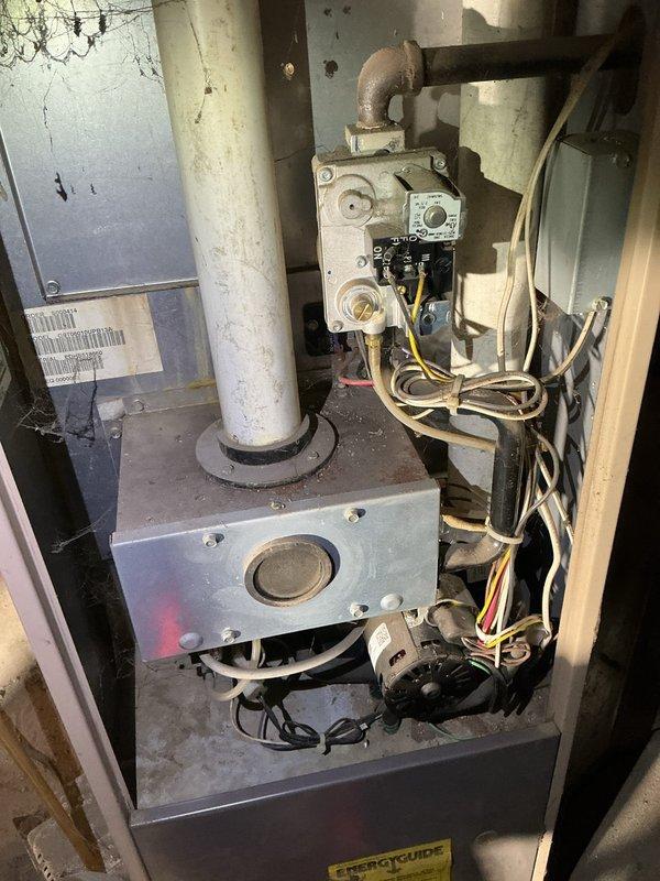 Responded to no heat call on Coleman-Evcon gas furnace over 20 years old. Upon inspection, found blower motor would not run consistently and had leaked oil. Diagnosed failed run capacitor as primary cause of intermittent blower operation. Verified heat exchanger integrity with no cracks or damage detected. Replaced failed run capacitor and blower motor to restore proper system operation. System tested successfully with blower running continuously and heat functioning normally.