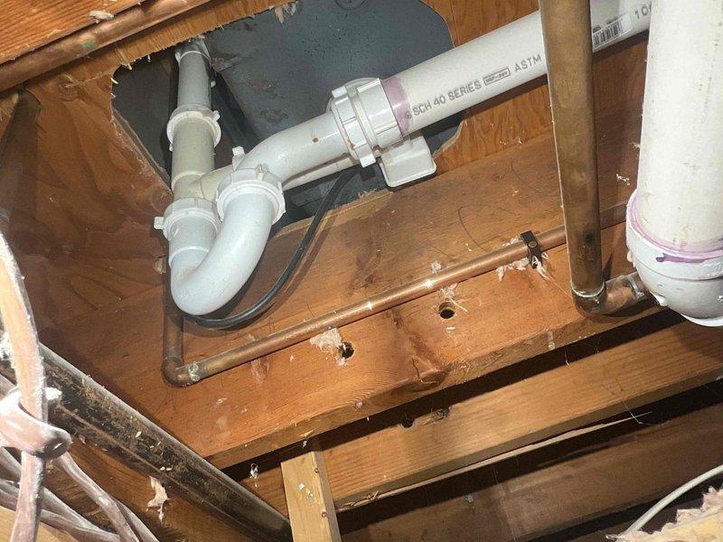 Responded to service call for moisture appearing through drywall with concern about ductwork leakage. Conducted thorough inspection of ductwork system and attic space, finding no active leaks in the duct system. Identified complete absence of insulation in attic as probable cause of condensation issue. Documented conditions with photos showing ceiling moisture staining, exposed floor joists, and plumbing infrastructure in uninsulated attic space. Advised customer that condensation on uninsulated ducts during cooling operation is likely source of moisture infiltration. Recommended adding proper attic insulation to prevent future condensation issues. Offered option to return during warmer weather for further diagnostic evaluation if moisture concerns persist after insulation improvements are made.