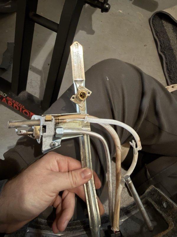 Responded to no hot water complaint on a 2-year-old AO Smith water heater that would not ignite. Upon inspection, discovered the thermopile wire was burnt through, preventing the pilot from staying lit. Removed and documented the damaged thermopile assembly for warranty claim processing and scheduled return visit to install replacement thermopile under manufacturer warranty coverage.