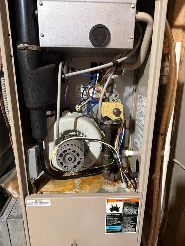Responded to service call for water leak on Lennox Elite Series furnace. Upon inspection, identified water leaking from inducer motor assembly. Further diagnostic evaluation revealed a compromised heat exchanger, which is the root cause of the water intrusion. Due to the severity of the heat exchanger failure and associated safety concerns, the unit was deemed unsafe for continued operation. Documented findings with photographs showing interior components, water staining on base panel, and overall system condition. Provided customer with replacement system quote given the extent of damage and age of equipment.