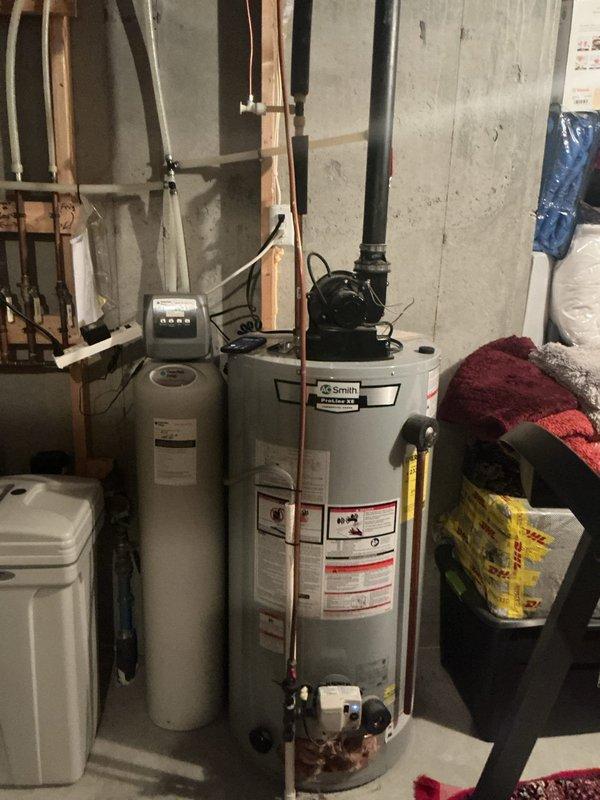 Responded to no hot water complaint on residential water heater experiencing soft lockout condition. Upon inspection, observed ignition control attempting to light but immediately shutting down when viewed through viewport, indicating flame sensor or gas valve failure. Diagnosed unit as beyond economical repair due to failed Honeywell gas control valve and age of equipment. Removed existing tanked water heater from utility area and provided replacement options. Completed full system evaluation including venting, gas supply lines, and electrical connections to ensure proper specifications for new installation.