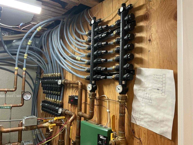 Performed preventive maintenance tune-up on natural gas Burnham boiler with hydronic radiant floor heating system. Conducted comprehensive inspection revealing system pressure was low, replenished water to proper operating level and instructed homeowner on maintenance procedure. Inspected all infloor loops, zone valves, circulator pumps, and manifold distribution system—all functioning properly. Evaluated piping, heat exchanger, and burner assembly with satisfactory results. Performed combustion analysis with acceptable readings and confirmed no carbon monoxide leaks detected. Noted backflow preventer is leaking and requires attention. Pressure relief valve tested and operating correctly. All heating zones confirmed operational and delivering heat properly at time of inspection.