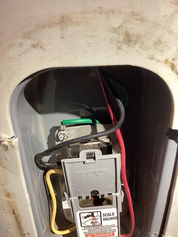 Responded to no hot water condition on 85-gallon electric water heater. Found ECO/safety shutoff had tripped due to overheating event. Reset ECO switch and verified power delivery to both thermostats and heating elements. Identified and cleaned burnt electrical connection at upper terminal and addressed corroded ground wire connection. Restored power to unit and confirmed proper voltage at both thermostats and heating elements. Unit operational at time of departure, though advised replacement should be considered due to age and condition of electrical components showing signs of deterioration.