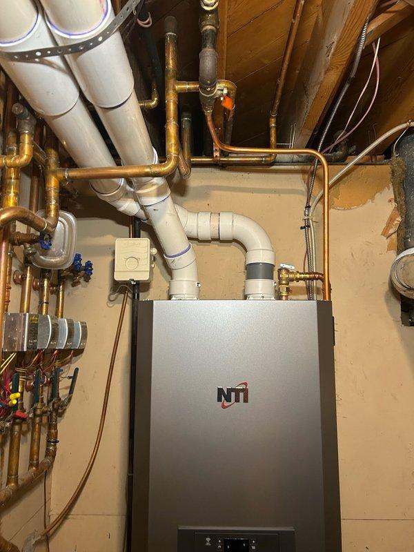 Completed annual fall boiler inspection and preventive maintenance tune-up on NTI heating system. Performed comprehensive inspection of flame sensor and ignition system, cleaning both components to ensure optimal performance. Inspected water pump, baseboard heating distribution system, condensation pump, and gas valve for proper operation. Conducted combustion analysis and gas pressure testing, achieving 98.1% efficiency rating. Performed scope inspection of heat exchanger with no defects identified. Tested all four heating zones, verifying zone valves are opening and closing properly for each circuit. Confirmed carbon monoxide levels are safe and within acceptable parameters. Checked system water pressure gauges and verified readings are within normal operating range. System is functioning properly with high efficiency heating output and no operational concerns identified at time of service.