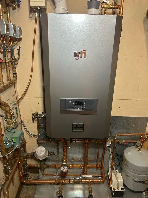 Completed annual fall boiler inspection and preventive maintenance tune-up on NTI heating system. Performed comprehensive inspection of flame sensor and ignition system, cleaning both components to ensure optimal performance. Inspected water pump, baseboard heating distribution system, condensation pump, and gas valve for proper operation. Conducted combustion analysis and gas pressure testing, achieving 98.1% efficiency rating. Performed scope inspection of heat exchanger with no defects identified. Tested all four heating zones, verifying zone valves are opening and closing properly for each circuit. Confirmed carbon monoxide levels are safe and within acceptable parameters. Checked system water pressure gauges and verified readings are within normal operating range. System is functioning properly with high efficiency heating output and no operational concerns identified at time of service.