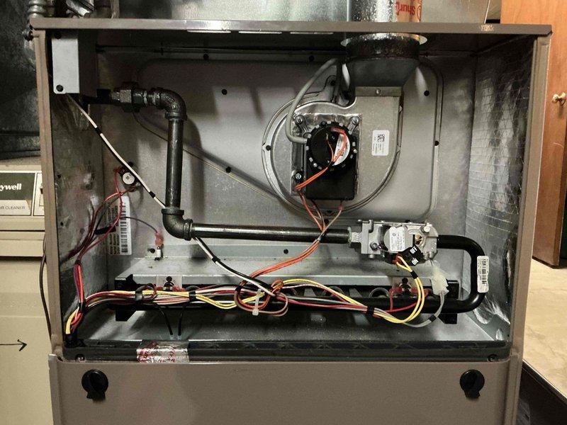 Performed comprehensive maintenance inspection on 16-year-old York furnace system. Verified ignition and flame safety systems operating properly, confirmed burners clean and heat exchanger in good condition. Adjusted gas pressure from low reading to manufacturer specification of 3.5" WC. Verified amp draws within acceptable range, combustion analysis satisfactory, blower wheel clean, control board functioning correctly, and temperature rise within specification. Replaced air filter. All system components operating as designed with no deficiencies noted.