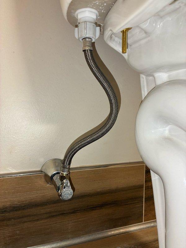 Responded to water staining around upstairs toilet. Upon inspection, flushed toilet multiple times to verify leak source was not at the base. Identified active leaks at both the supply line and angle stop valve. Removed existing SharkBite angle stop and installed a standard PEX angle stop. Replaced the toilet supply line with new braided stainless steel flexible connector. Verified all connections were secure and leak-free upon completion.