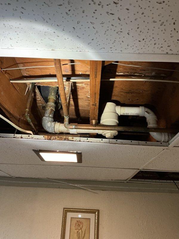 Responded to service call for multiple plumbing issues including toilet leak, basement ceiling water damage, and dripping tub drain. Replaced wax seal on toilet to eliminate leak at floor connection. Installed two new shut-off valves on toilets to ensure proper water control and prevent future leaks. Repaired tub drain to stop dripping issue. Upon inspection of basement ceiling tiles, identified source of water intrusion from bathroom plumbing above. All fixtures tested for proper operation and verified leak-free after repairs completed.