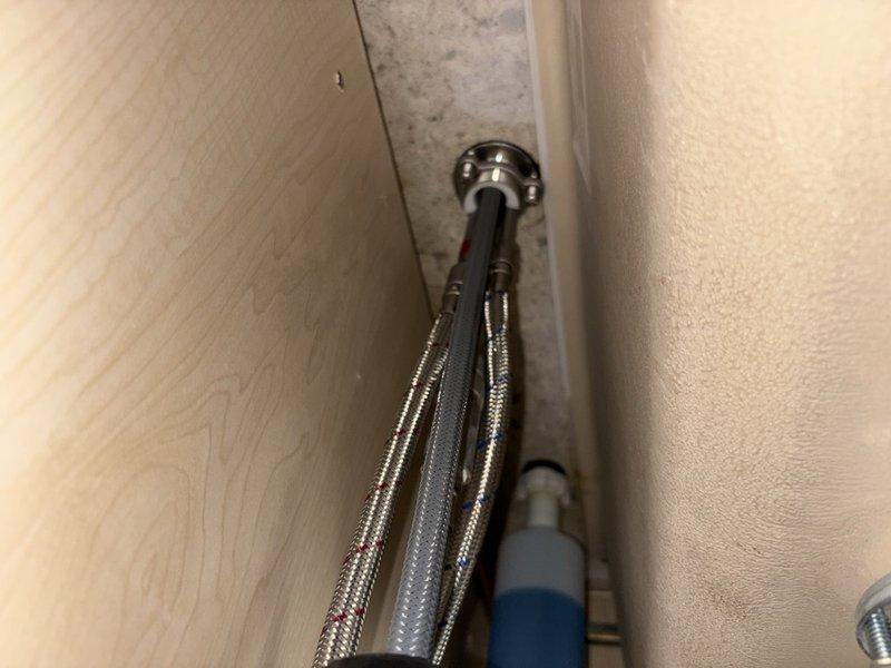 Responded to reported leak under kitchen sink. Upon arrival, found cold supply valve in closed position and reopened for inspection. Identified loose hot and cold water supply tubes at shut-off valves showing signs of previous leakage and water damage. Tightened both supply line connections at valve interface to proper torque specifications. Conducted 30-minute pressure test by running water through faucet, alternating between hot and cold supplies to verify repair integrity. No active leaks detected during testing period. Verified all connections secure and left system in full operational service.