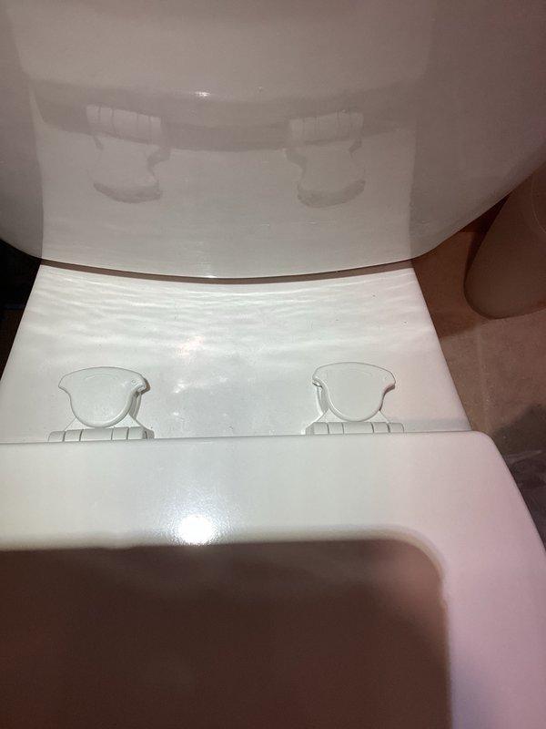 Responded to callback for loose toilet seat on recently installed toilet. Upon inspection, discovered right side locking mechanism was not fully engaged. Removed toilet seat, verified bolt tightness, reinstalled seat ensuring both locking mechanisms were properly secured, and performed pull test to confirm stability. Customer advised that alternative seat options are available if issue recurs.