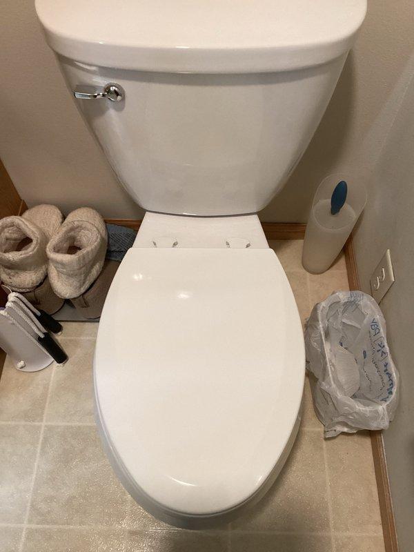 Responded to callback for loose toilet seat on recently installed toilet. Upon inspection, discovered right side locking mechanism was not fully engaged. Removed toilet seat, verified bolt tightness, reinstalled seat ensuring both locking mechanisms were properly secured, and performed pull test to confirm stability. Customer advised that alternative seat options are available if issue recurs.