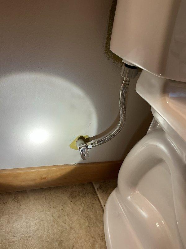 Responded to a return visit for leaking toilet supply connections. Upon inspection, found the original shut-off valve at the wall connection was leaking and required replacement. Removed the old defective shut-off valve and installed a new quarter-turn valve at the wall connection point. Replaced the existing supply line with a new braided stainless steel flexible supply line, ensuring proper connection between the new quarter-turn valve and toilet tank inlet. Tested the system for leaks and verified proper operation of the shut-off valve.