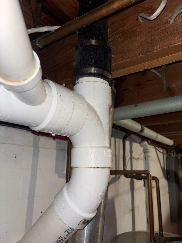 Responded to an active water leak originating from the dishwasher area that was dripping into the basement and coming into contact with electrical wiring. Upon investigation, determined that the dishwasher only leaked during operation, with water pouring from the housing unit. Identified the issue as an appliance malfunction rather than a plumbing system failure. Documented the plumbing infrastructure and HVAC components in the affected basement area. Advised homeowner to contact an appliance repair specialist to address the dishwasher defect, as the unit is only two years old and the leak is isolated to the appliance itself rather than the home's plumbing system.