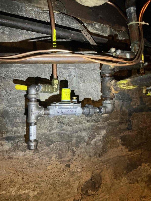 Responded to gas leak emergency in basement following utility company detection of multiple leak points. Confirmed six separate gas leaks in basement gas lines that were not detectable by odor. Documented leak locations with photographs showing compromised piping infrastructure, including multiple brass fittings, valves, and connection points in aged plumbing system. Coordinated scheduling with licensed plumber for comprehensive gas line repairs to address all identified leak points and restore safe operation of gas system.