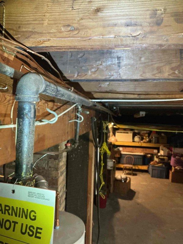 Responded to service call for leaking faucet and clogged bathroom sink. Upon arrival, identified multiple gas leaks throughout the property that had been previously marked by CenterPoint Energy. Inspection revealed deteriorated gas piping system with aged galvanized steel lines and failing valves running through basement crawl space. Documented extensive gas leak locations with photographic evidence showing compromised piping infrastructure, including vertical runs with corroded fittings and manifold connections with multiple valve points. Due to the severity and scope of gas system deficiencies, scheduled master plumber to provide comprehensive bid for complete gas line repipe to ensure safe operation and code compliance.
