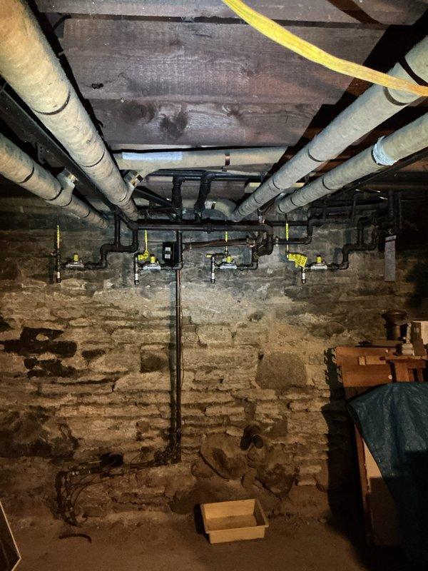 Responded to service call for leaking faucet and clogged bathroom sink. Upon arrival, identified multiple gas leaks throughout the property that had been previously marked by CenterPoint Energy. Inspection revealed deteriorated gas piping system with aged galvanized steel lines and failing valves running through basement crawl space. Documented extensive gas leak locations with photographic evidence showing compromised piping infrastructure, including vertical runs with corroded fittings and manifold connections with multiple valve points. Due to the severity and scope of gas system deficiencies, scheduled master plumber to provide comprehensive bid for complete gas line repipe to ensure safe operation and code compliance.