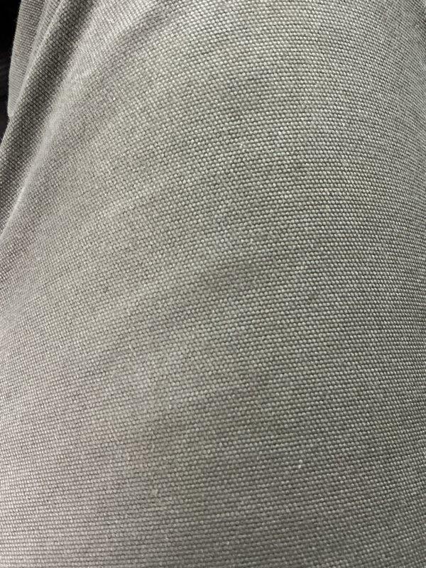 Completed follow-up call to provide requested license number information. Documented fabric material condition through photographic inspection, capturing detailed views of woven textile with uniform weave pattern and no visible defects.