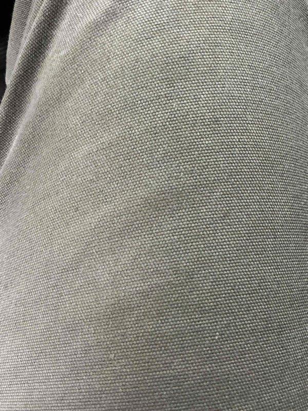 Completed follow-up call to provide requested license number information. Documented fabric material condition through photographic inspection, capturing detailed views of woven textile with uniform weave pattern and no visible defects.