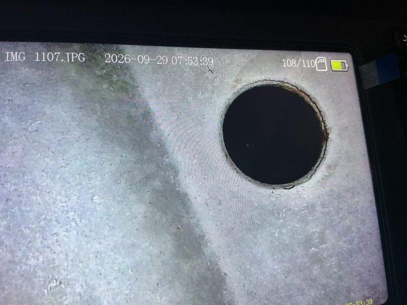 Performed furnace tune-up on 28-year-old unit and discovered critical safety issues including a blower motor leaking oil and multiple visible cracks around the eyelets of the bottom left heat exchanger chamber with carbon monoxide leaking outside the system during operation. Tagged unit as unsafe to operate due to compromised heat exchanger integrity and scheduled estimate for furnace replacement.