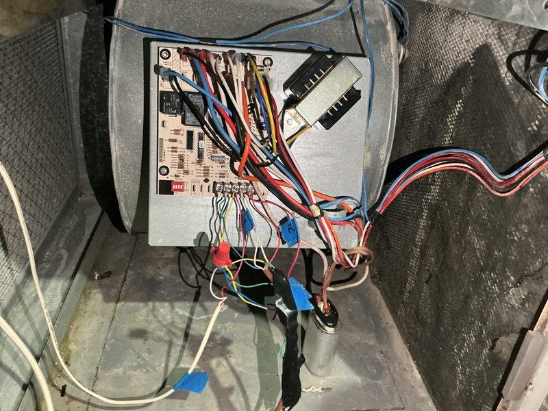 Performed furnace tune-up on 28-year-old unit and discovered critical safety issues including a blower motor leaking oil and multiple visible cracks around the eyelets of the bottom left heat exchanger chamber with carbon monoxide leaking outside the system during operation. Tagged unit as unsafe to operate due to compromised heat exchanger integrity and scheduled estimate for furnace replacement.