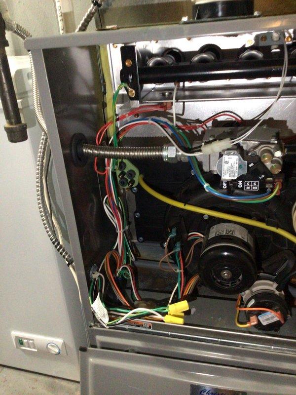 Completed furnace tune-up on 12-year-old residential heating unit. System operational with normal performance parameters. Identified two code violations requiring correction: high voltage wiring terminated with wire nuts and left unsecured inside cabinet, and flexible metal gas connector improperly installed directly to gas valve without proper fittings. Documented conditions with photos and provided estimate for code compliance repairs including proper junction box installation and gas line correction with appropriate connectors and fittings.