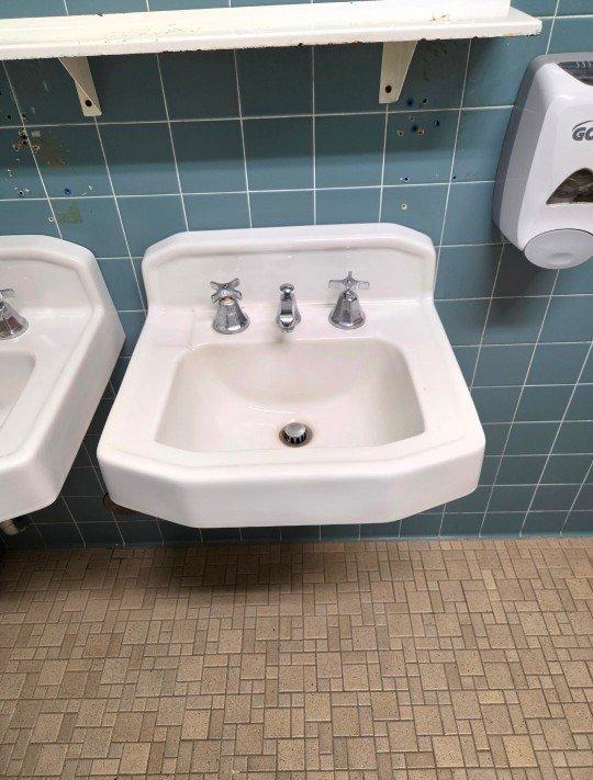 Conducted site assessment of commercial restroom facilities to evaluate plumbing issues and provide repair estimates. Inspected leaking urinal and toilet flush valve in converted female restroom, recommending replacement of two flush valve assemblies. Evaluated two wall-mounted sinks with seized cold water handles on widespread faucet installations, determining that complete faucet replacement would be necessary due to operational difficulty. Provided complimentary estimates for installation of two new flush valves and four new widespread faucets with chrome finish to restore proper function to commercial bathroom fixtures.
