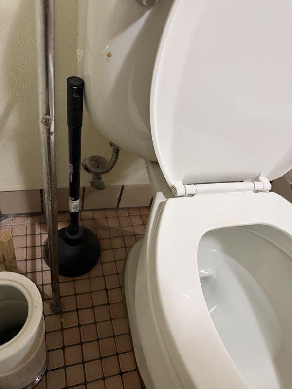 Responded to service call for toilet replacement estimate. Assessed existing standard residential toilet in bathroom with small square tile flooring. Evaluated installation requirements and provided written estimate for replacement with new ADA-compliant toilet fixture, including documentation with photographs of current conditions and plumbing connections.