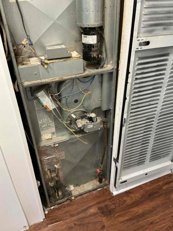 Responded to report of leak from furnace during air conditioning operation at vacant property. Performed diagnostic inspection of mobile home furnace unit and associated refrigerant lines. Operated air conditioning system for 25 minutes while monitoring all copper lines running to outdoor condenser unit and furnace connections. No condensation observed on refrigerant lines during extended runtime test. Identified that copper pipes with visible condensation run horizontally across basement area, separate from HVAC refrigerant lines. Determined moisture issue is unrelated to air conditioning system and most likely originating from nearby plumbing water lines experiencing condensation due to temperature differential. Recommended installation of dehumidifier in basement to address ambient moisture levels or consultation with licensed plumber to insulate affected water lines and resolve condensation concern.