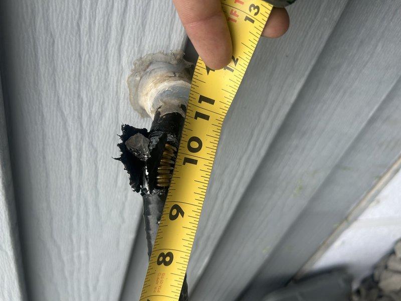 Responded to gas leak call on exterior gas line damaged by landscaping contractor. Upon arrival, performed leak detection test and visual inspection of gas piping on east side of residence. Located damage to gas line where landscaping equipment had nicked the pipe, compromising the metallic shield with a cut exceeding half an inch in length. The damage penetrated through multiple layers, exposing the bottom layer of the gas pipe structure. Documented damage with measurements and photographs showing extent of deterioration to protective coating and metallic shielding. Determined that the affected section requires removal and splicing to restore system integrity and safety. Advised homeowner that damaged pipe section must be cut out and replaced with proper gas line splicing procedures to meet code requirements. Collected diagnostic information and provided recommendations for repair scope. Follow-up pricing for gas line repair to be provided to homeowner.