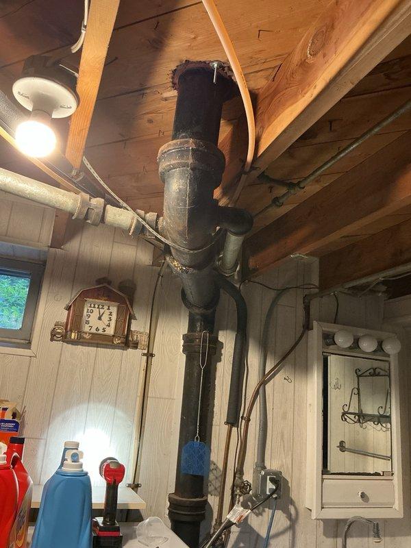 Responded to complaint of strong sewage smell concentrated near bathroom sink wall. Conducted thorough diagnostic testing by running various fixtures but was unable to replicate the odor during service visit. Inspected all accessible plumbing components including drain lines, trap assemblies, and visible piping. Determined that a vent pipe concealed within the wall cavity could not be visually inspected and is suspected to have developed a breach or crack allowing sewer gas to escape into the living space. Documented existing plumbing infrastructure including aging black iron pipes and galvanized connections in basement utility area. Scheduled emergency follow-up service to access and replace the suspected compromised vent pipe section behind the wall.