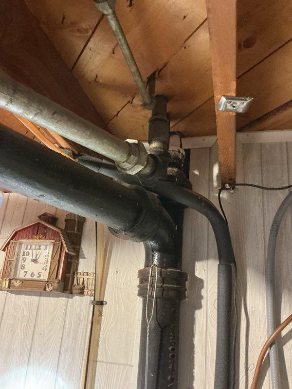 Responded to complaint of strong sewage smell concentrated near bathroom sink wall. Conducted thorough diagnostic testing by running various fixtures but was unable to replicate the odor during service visit. Inspected all accessible plumbing components including drain lines, trap assemblies, and visible piping. Determined that a vent pipe concealed within the wall cavity could not be visually inspected and is suspected to have developed a breach or crack allowing sewer gas to escape into the living space. Documented existing plumbing infrastructure including aging black iron pipes and galvanized connections in basement utility area. Scheduled emergency follow-up service to access and replace the suspected compromised vent pipe section behind the wall.