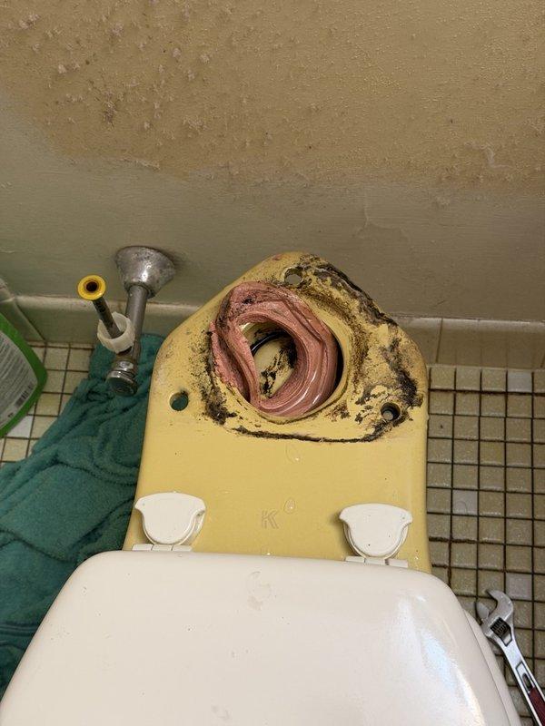 Responded to leak between floor and toilet. Upon inspection, identified failed wax ring gasket and corroded closet bolts as source of water infiltration. Removed toilet from flange, cleaned mounting surface, and replaced deteriorated wax ring gasket with new seal. Installed new closet bolts and hardware. Reset toilet to flange, ensuring proper alignment and secure mounting. Tested flush operation and verified leak resolution with no water seepage at base.