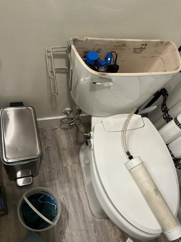Responded to bathroom plumbing issues including sewer gas odor, toilet leaking at base, and tub spout leaking at wall connection. Removed defective tub spout that was leaking water from back when shower was running and installed temporary cap to allow continued shower use until homeowner replaces fixture. Pulled and reset toilet to eliminate rocking and seal properly at base, resolving leak and sewer gas smell.