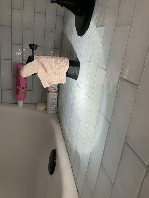 Responded to bathroom plumbing issues including sewer gas odor, toilet leaking at base, and tub spout leaking at wall connection. Removed defective tub spout that was leaking water from back when shower was running and installed temporary cap to allow continued shower use until homeowner replaces fixture. Pulled and reset toilet to eliminate rocking and seal properly at base, resolving leak and sewer gas smell.