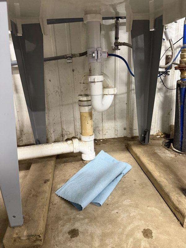 Responded to callback for reported water leakage under laundry tub following previous drain cleaning service. Upon arrival, no active water was visible on floor. Removed P-traps from laundry tub drain assembly and applied pipe dope to all threaded connections to ensure proper seal. Reassembled drain components and conducted thorough leak testing by filling laundry tub to capacity three separate times and monitoring all connections during drainage cycles. No leaks detected during testing procedures, and all plumbing connections remained dry throughout verification process.
